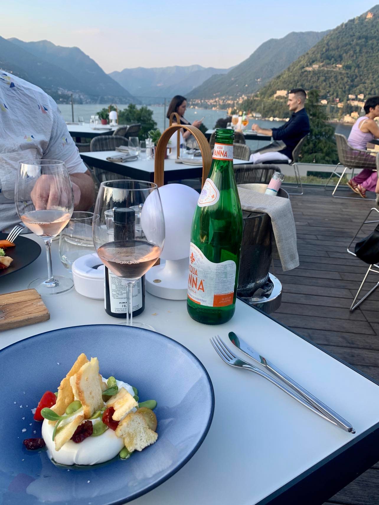 hilton lake como eating dinner at the roof top bar