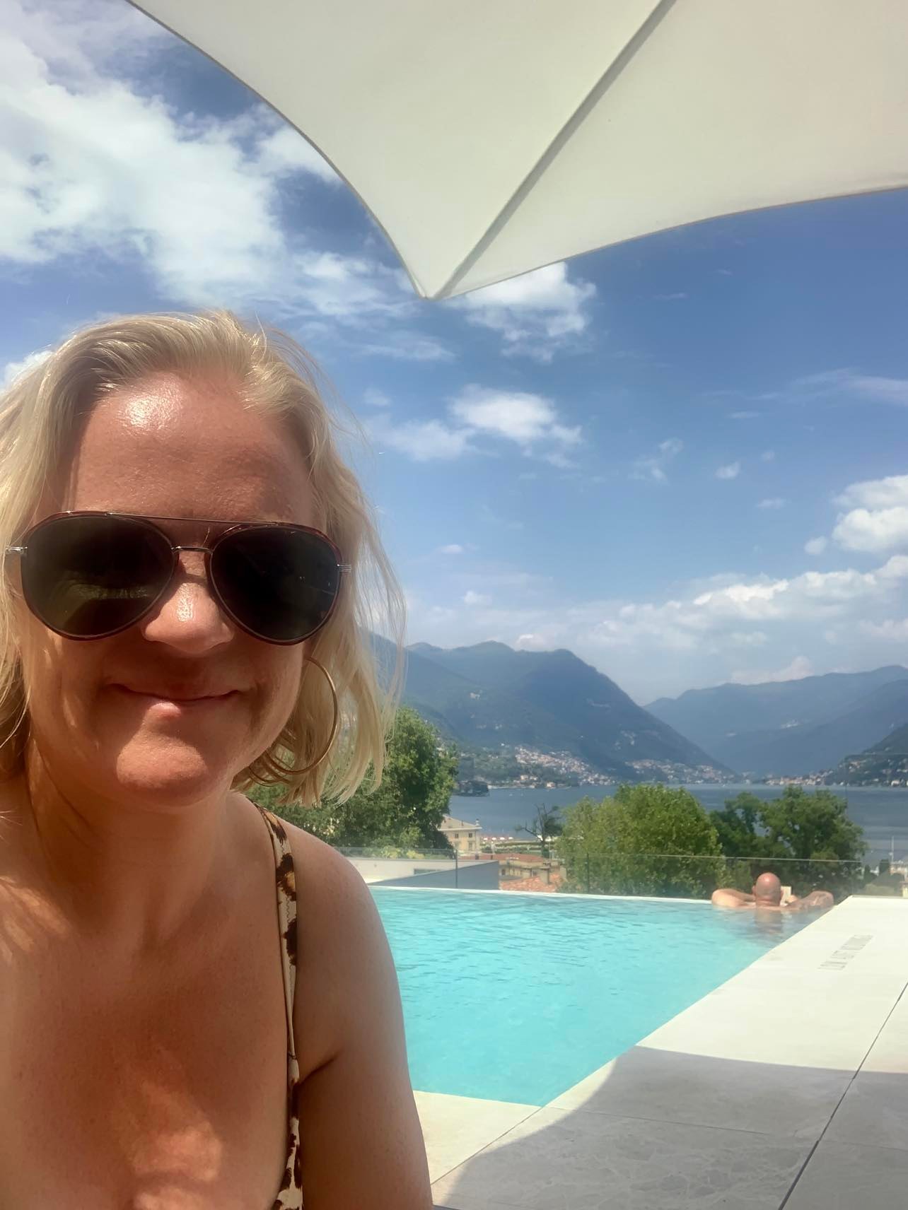 sitting by the pool at the hilton lake como hotel, our holiday review