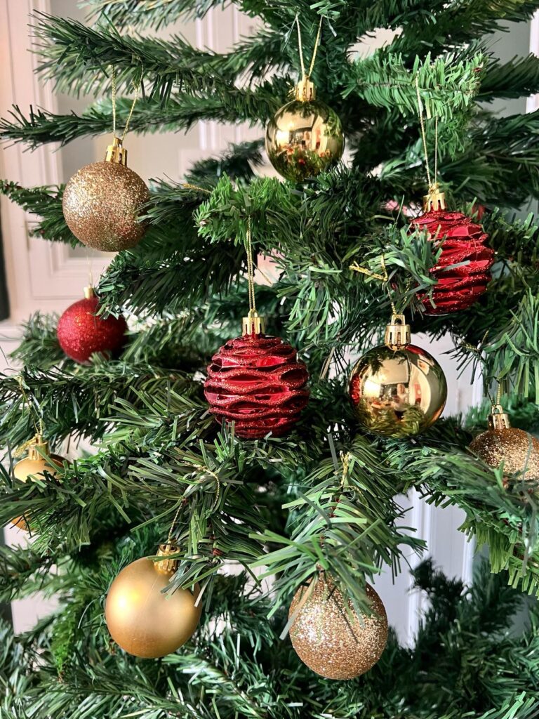 we are christmas website order review, red and gold baubles on a tree