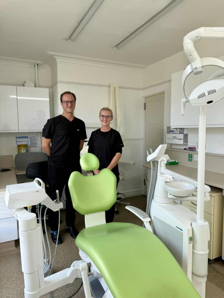 Dentist and Nurse at Lighthouse dental practice standing behind dental chair 