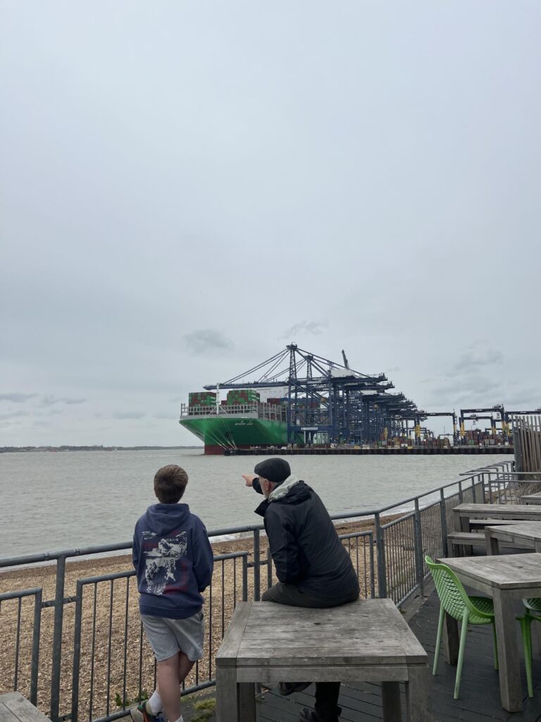 man and boy viewing the ships coming into port at felixstowe landguard port